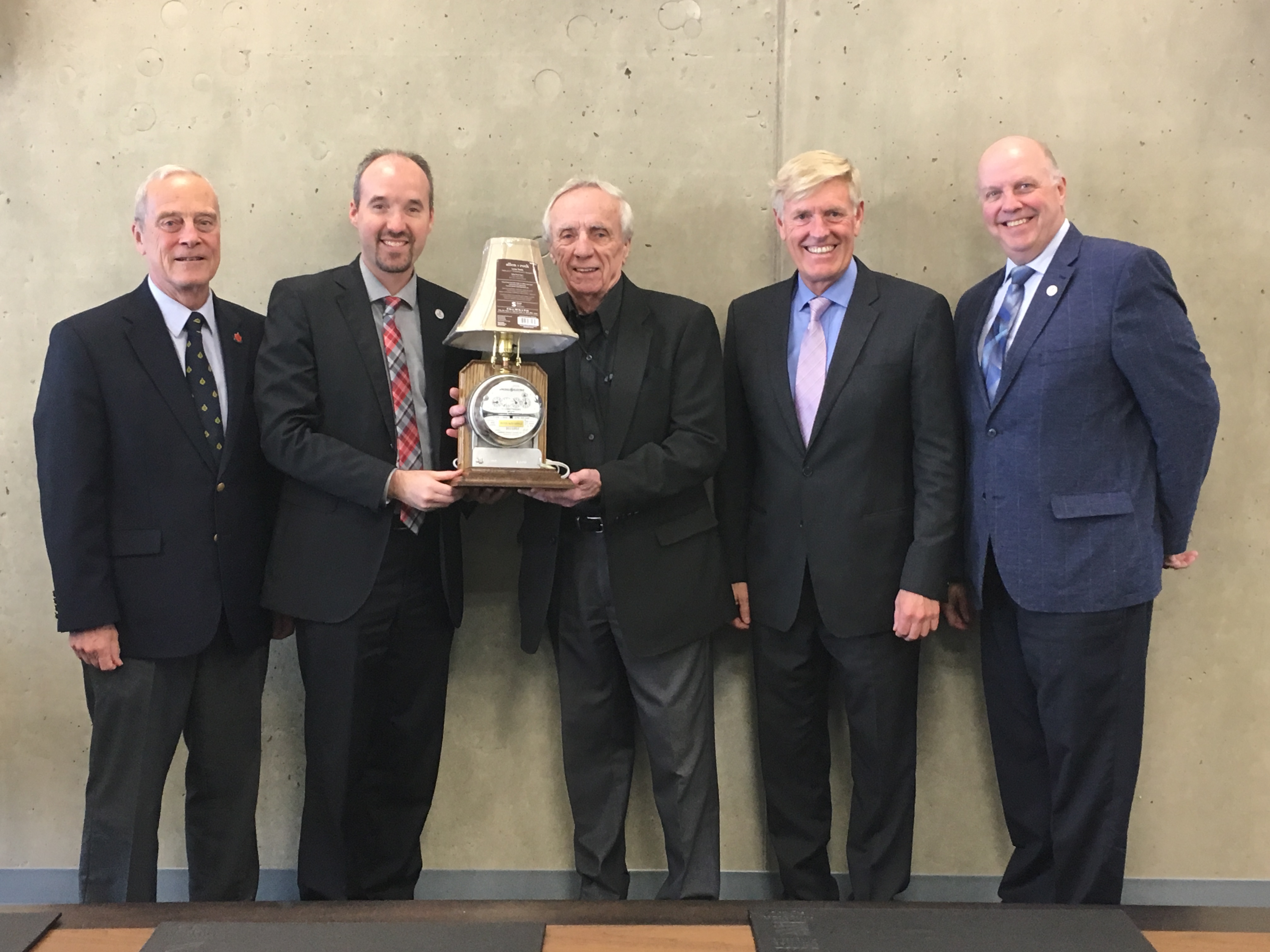 The Kingston Hydro Board of Directors presents Ron Doyle with an award upon his retirement