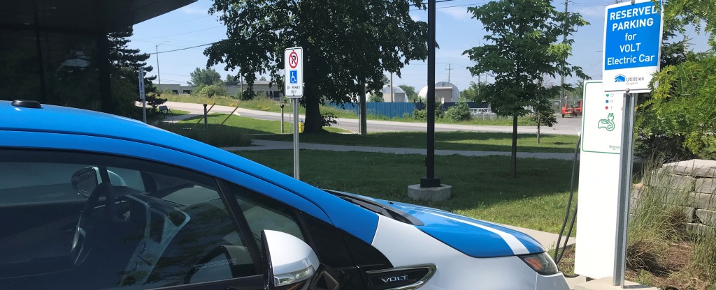 A Utilities Kingston electric vehicle parked at a charging station